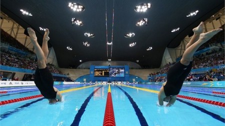 Two swimmers dive into the pool at the Aquatics Centre during the London 2012 Paralympics.