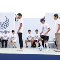 A blind footballer weaves between two people