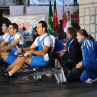 Three rowers compete indoors