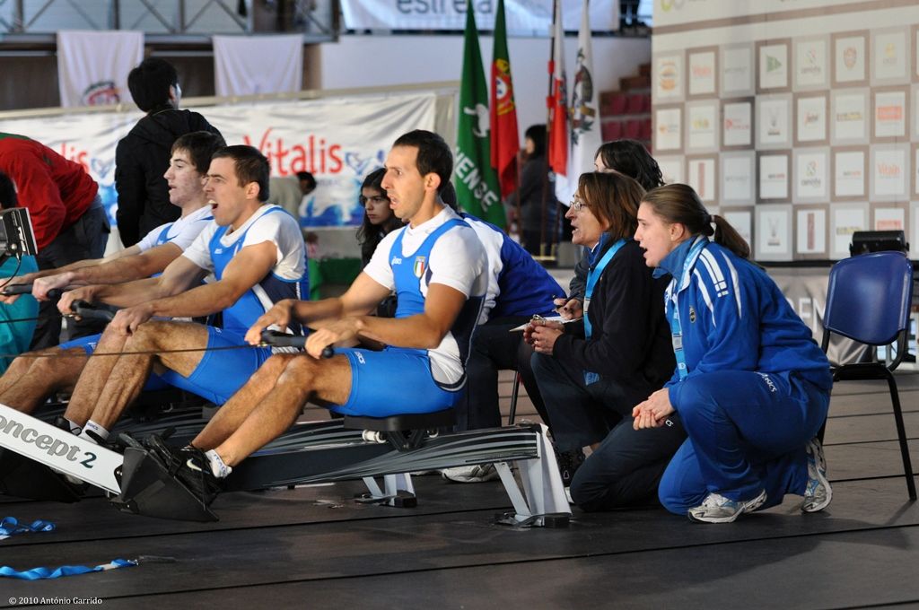 Three rowers compete indoors