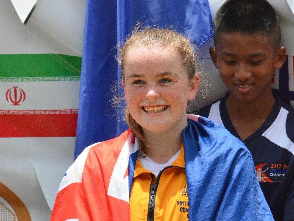 An athlete with an intellectual impairment smiles after receiving her medal