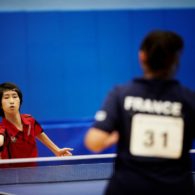 Two female table tennis players play a match