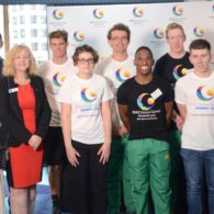 A group of dignitaries and athletes pose for a group shot for the 2019 Global Games