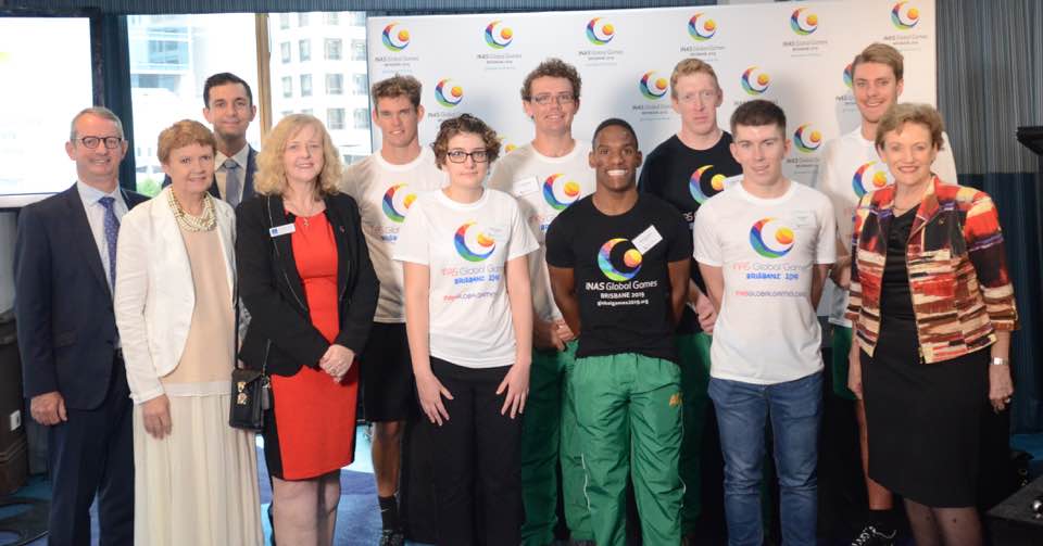 A group of dignitaries and athletes pose for a group shot for the 2019 Global Games