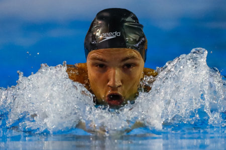 A swimmer, Felipe Caltran Vila Real, emerges from the water