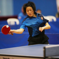 A table tennis player is pictured mid shot