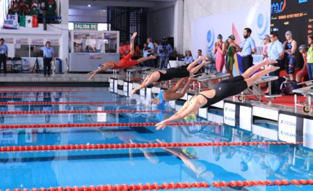 Women dive into the pool at the 2017 World Intellectual Impairment Sport Swimming Championships