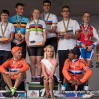 Cyclist with intellectual impairments line-up on the podium after receiving their medals