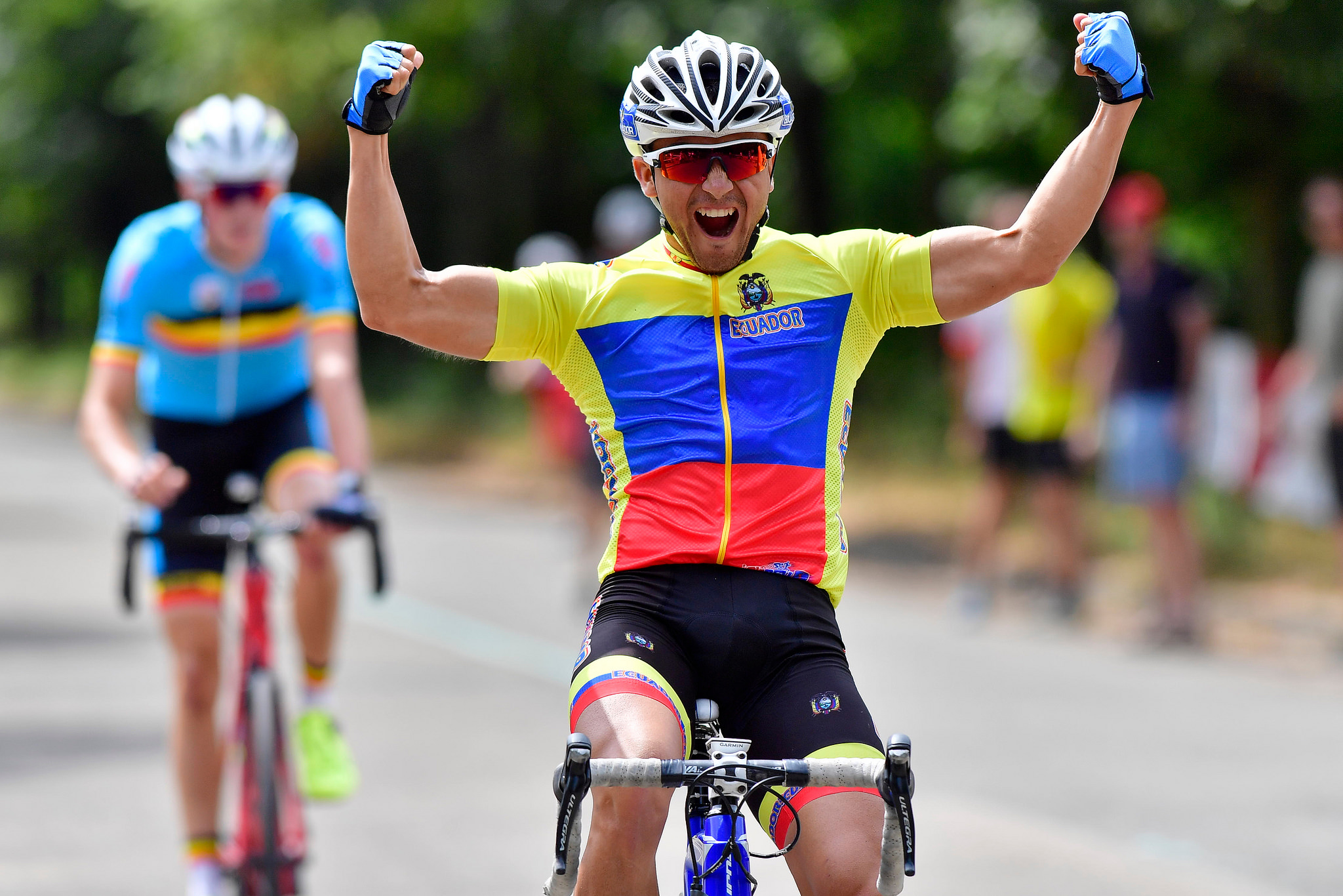 Eric Sarango Tufino clenches his fists as he crosses the finish line at the 2018 World Intellectual Impairment Sport Cycling World Championships