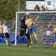 A Swedish players leaps into the air to head the ball towards goal