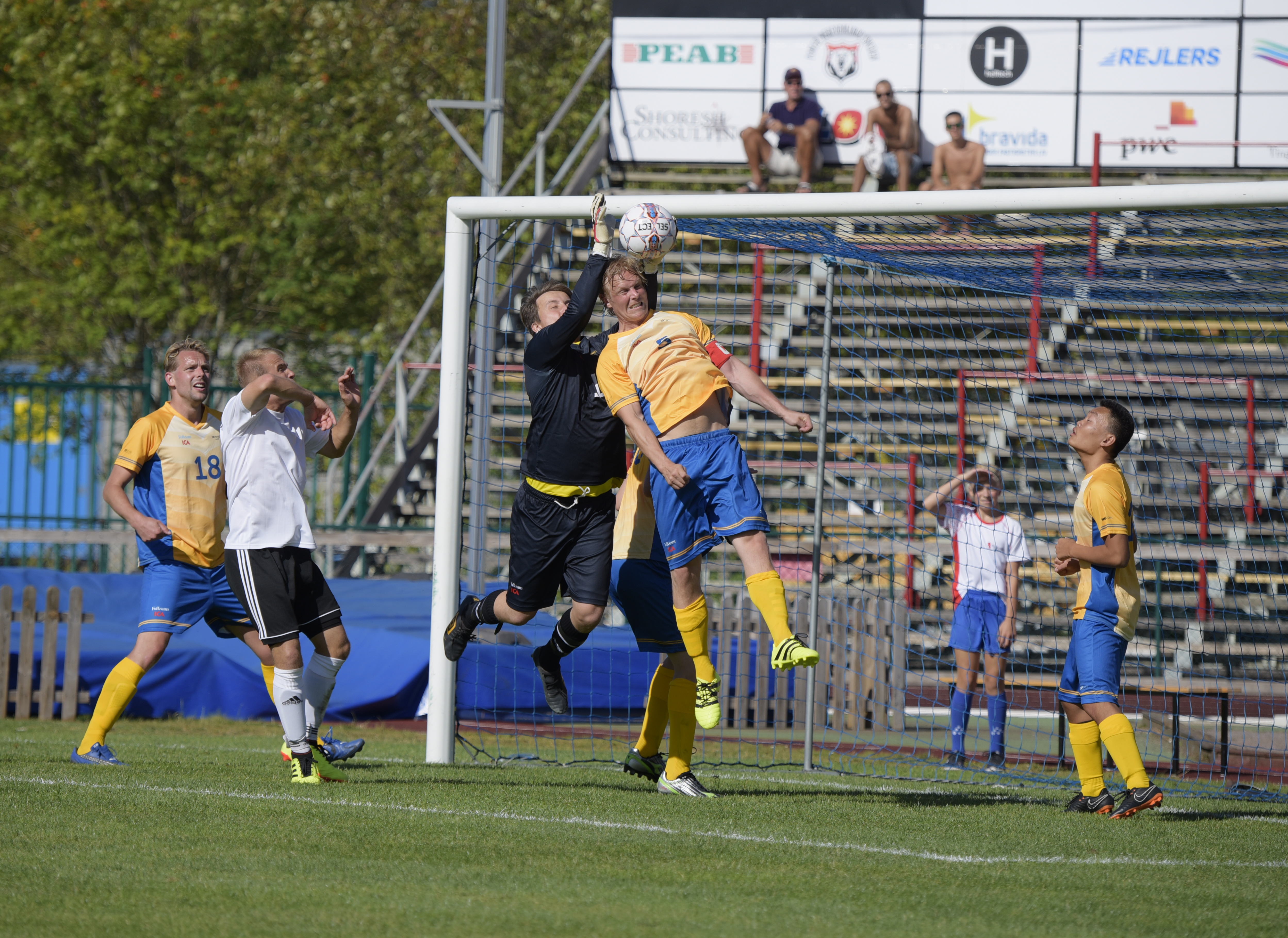 A Swedish players leaps into the air to head the ball towards goal