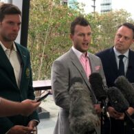 Daniel Fox, Jeff Horn and Brisbane Lord Mayor Adrian Schrinner stand in front of microphones