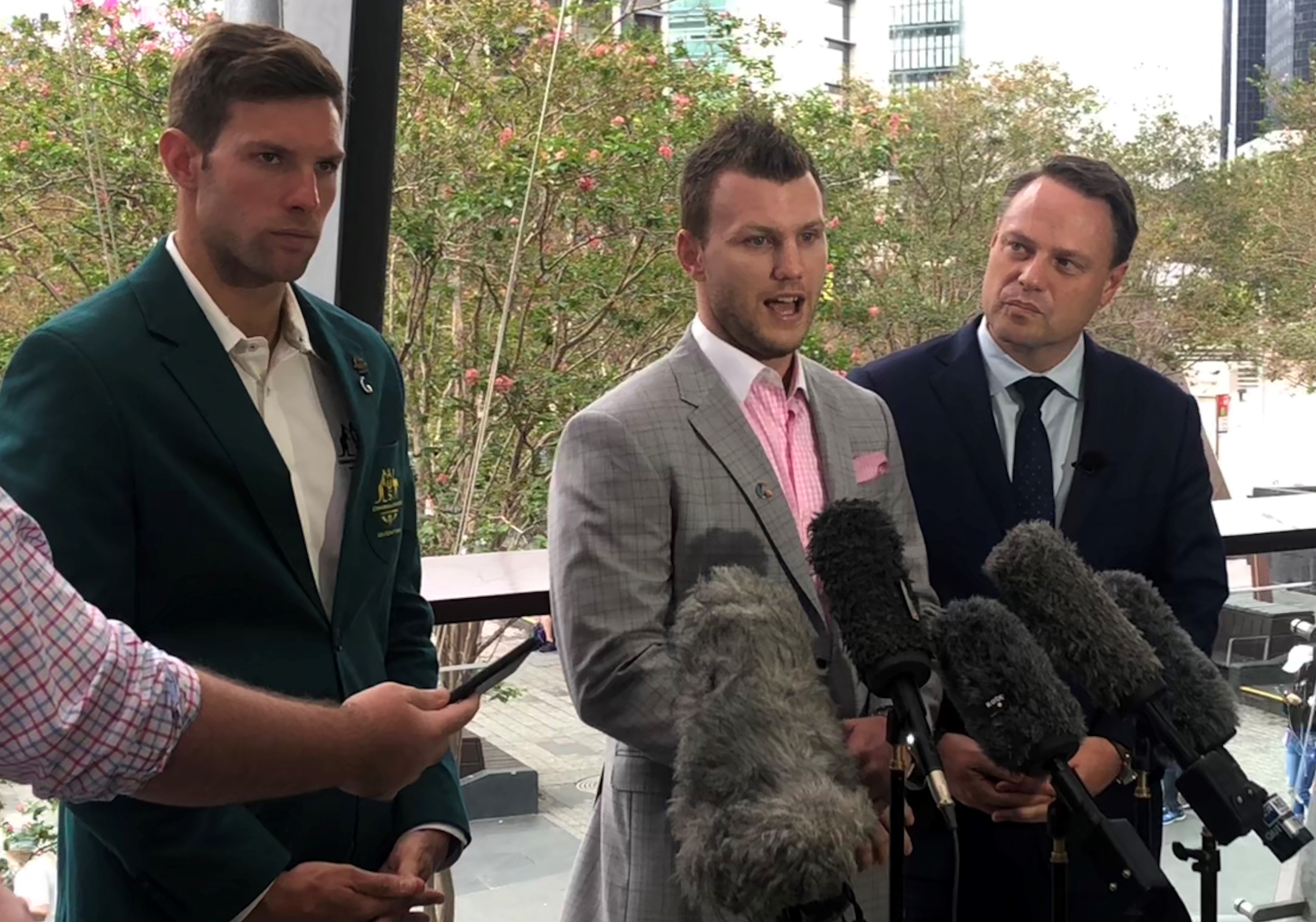 Daniel Fox, Jeff Horn and Brisbane Lord Mayor Adrian Schrinner stand in front of microphones