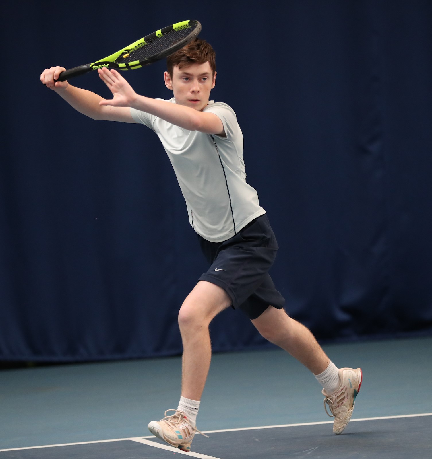 Luke Turnbull is pictured as he is about to strike the ball with his tennis racket