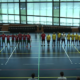 Handball players standing shoulder to shoulder standing on a handball court